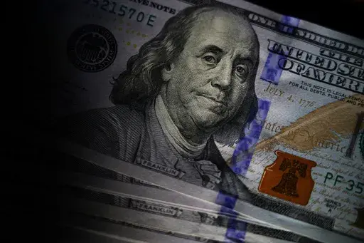The likeness of Benjamin Franklin is seen on U.S. $100 bills, July 14, 2022, in Marple Township, Pa. In 2023, the Federal Trade Commission received over 64,000 romance scams reports that translated into $1.14 billion in reported losses. (AP Photo/Matt Slocum, File)