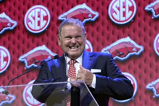 Arkansas head football coach Sam Pittman reaches into his pocket while speaking during the Southeastern Conference NCAA college football media days Thursday, July 18, 2024, in Dallas. (AP Photo/LM Otero)