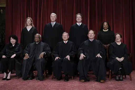 Members of the Supreme Court sit for a new group portrait following the addition of Associate Justice Ketanji Brown Jackson, at the Supreme Court building in Washington, Oct. 7, 2022. Bottom row, from left, Associate Justice Sonia Sotomayor, Associate Justice Clarence Thomas, Chief Justice of the United States John Roberts, Associate Justice Samuel Alito, and Associate Justice Elena Kagan. Top row, from left, Associate Justice Amy Coney Barrett, Associate Justice Neil Gorsuch, Associate Justice 