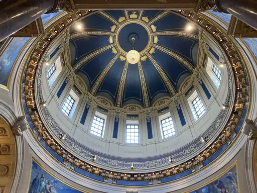 The "electrolier" is lit in the Minnesota State Capitol dome in St. Paul, Minn., Thursday, May 11, 2023, to mark Statehood Day, Minnesota's 165th birthday. The electrolier," an old term for "electric chandelier," is over 100 years old, dating from when electricity was new. It measures 6 feet in diameter, contains 92 light bulbs and hangs over 140 feet above the floor in the Capitol Rotunda. It's lit only on special occasions, such as the annual Statehood Day or on the first days of legislative s