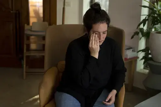 Yifat Zailer, whose cousin Sheri Bibas and Bibas' husband and sons were taken hostage by Hamas militants, weeps during an interview at her home in Herziliyya, Israel, Wednesday, Jan. 15, 2025. (AP Photo/Maya Alleruzzo)