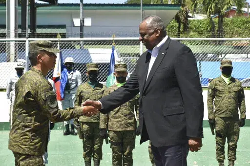 In this handout photo provided by the Command Public Information Office, Western Mindanao Command, U.S. Defense Secretary Lloyd Austin III, right, greets Western Mindanao Commander Lt. Gen. Roy Galido as he visits Camp Don Basilio Navarro in Zamboanga province, southern Philippines on Wednesday Feb. 1, 2023. Austin is in the Philippines for talks about deploying U.S. forces and weapons in more Philippine military camps to ramp up deterrence against China's increasingly aggressive actions toward 