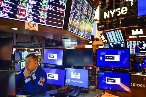 A trader works on the floor at the New York Stock Exchange in New York, Thursday, May 19, 2022. This year's sell-off for Wall Street means stocks no longer look to be in a dangerously overvalued bubble, as some critics had warned. Prices have retreated toward historical norms, when measured against corporate profits.  Analysts have so far been maintaining their expectations for corporate profits going forward.  (AP Photo/Seth Wenig, File)
