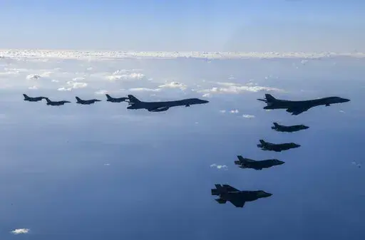 In this photo provided by South Korean Defense Ministry, two U.S. Air Force B-1B bombers, top center, four South Korean Air Force F-35 fighter jets and four US Air Force F-16 fighter jets fly over South Korea Peninsula during a joint air drill called "Vigilant Storm," in South Korea, Saturday, Nov. 5, 2022. North Korea added to its recent barrage of weapons demonstrations by launching four ballistic missiles into the sea on Saturday, as the United States sent two supersonic bombers streaking ove