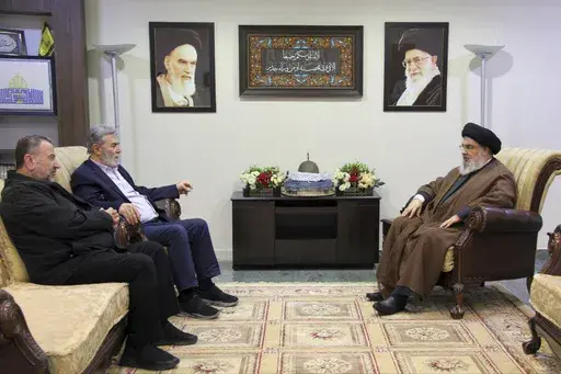 In this photo released on Wednesday, Oct. 25, 2023, by the Hezbollah Media Relations Office, Hezbollah leader Sayyed Hassan Nasrallah, right, meets with Ziad al-Nakhleh, the head of Palestinian Islamic Jihad, center, and Hamas deputy chief, Saleh al-Arouri, in Beirut, Lebanon. Nasrallah met with top Hamas and Palestinian Islamic Jihad officials, their first reported meeting since the Hamas-Israel war erupted earlier this month and clashes began along the Lebanon-Israel border. (Hezbollah Media R