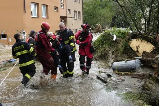A resident is evacuated from her flooded house in Jesenik, Czech Republic, Sept. 15, 2024. (AP Photo/Petr David Josek, File)
