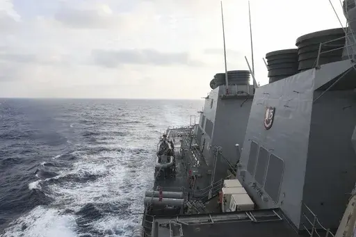 In this photo provided by the U.S. Navy, the Arleigh Burke-class guided-missile destroyer USS Milius (DDG 69) conducts routine underway operations in South China Sea, Friday March 24, 2023. China threatened “serious consequences” Friday, after the U.S. Navy sailed a destroyer around the disputed Paracel Islands in the South China Sea the second day in a row, which Beijing claimed was a violation of its sovereignty and security.(Mass Communication Specialist 1st Class Greg Johnson/U.S. Navy v