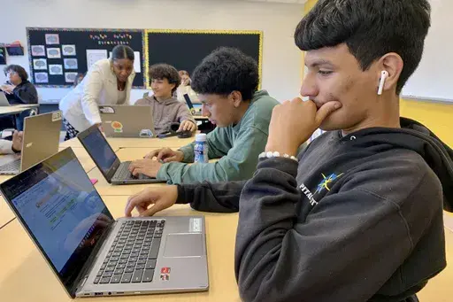 Bryan Martinez, a senior at Capital City Public Charter School in Washington, works on a computer during his Advanced Algebra with Financial Applications class on Sept. 12, 2023. For his medium-term financial goals, he settles on a car — he doesn’t have one yet — and vacations. Peering way into his future, the 18-year-old also imagines saving money to buy a house, start his own business, retire, and perhaps provide any children with a college fund. (Jackie Valley/The Christian Science Moni