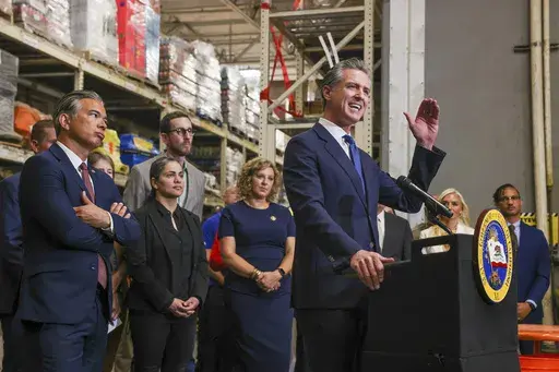 California Governor Gavin Newsom speaks as Attorney General Bob Bonta, second from left, looks on after signing a bipartisan package of bills to combat retail crime during a press conference with state and local officials at Home Depot in San Jose, Calif., on Friday, Aug. 16, 2024. (Ray Chavez/Bay Area News Group via AP)
