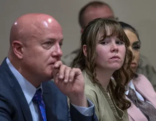 Hannah Gutierrez-Reed, center, sits with her attorney Jason Bowles and paralegal Carmella Sisneros during her sentencing hearing in Santa Fe, New Mexico, on Monday, April 15, 2024. Gutierrez-Reed, the armorer on the set of the Western film "Rust," was sentenced to 18 months in prison for involuntary manslaughter in the death of cinematographer Halyna Hutchins, who was fatally shot by Alec Baldwin in 2021. (Eddie Moore/The Albuquerque Journal via AP, Pool)