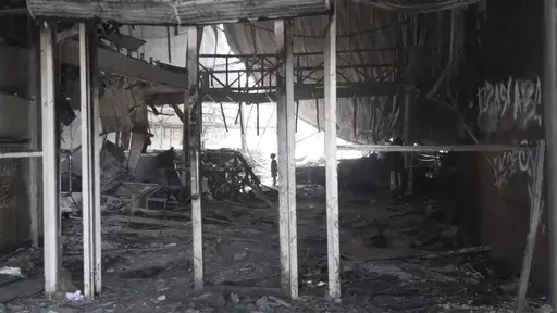 This image made from video shows the destroyed shopfront in Port Moresby, Papua New Guinea Thursday Jan. 11, 2024. The Papua New Guinea government worked to restore order Thursday after multiple people were reportedly killed during rioting and looting that left the country’s two biggest cities in flames. (Australian Broadcasting Corp. via AP)