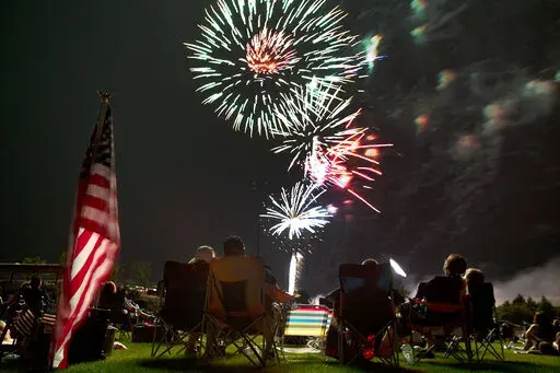 Spectators watch as fireworks explode overhead during the Fourth of July celebration at Pioneer Park, on July 4, 2013, in Prescott, Ariz. The skies over a scattering of Western cities will stay dark for the third consecutive Fourth of July in 2022 as some big fireworks displays are canceled again, this time for pandemic related supply chain or staffing problems, or fire concerns amid dry weather. The city of Phoenix cited supply chain issues in canceling its three major Independence Day firework