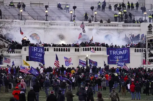 Violent rioters loyal to President Donald Trump storm the Capitol in Washington on Jan. 6, 2021. Lawsuits playing out in two states this week seeking to keep former President Donald Trump off the ballot rely on a constitutional clause barring those from office who “have engaged in insurrection.” One challenge has become clear during the hearings in Colorado and Minnesota: No one can agree on how to define an insurrection. (AP Photo/John Minchillo, File)
