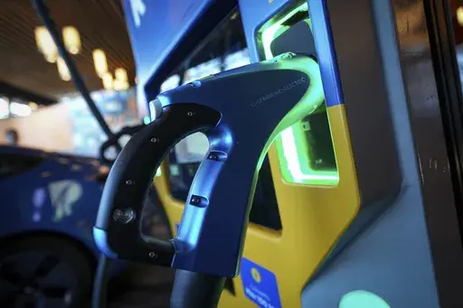 A DC fast charging station manufactured by Sumitomo Electric works at Fully Charged Live, an electric vehicle, renewable and clean energy and urban mobility exhibition, in Vancouver, British Columbia, Sept. 8, 2023. The window to limit human-caused warming to a globally agreed goal is narrowing but still open because of the huge growth of solar energy and electric vehicles sales worldwide, a report said Tuesday, Sept. 26. (Darryl Dyck /The Canadian Press via AP, File)