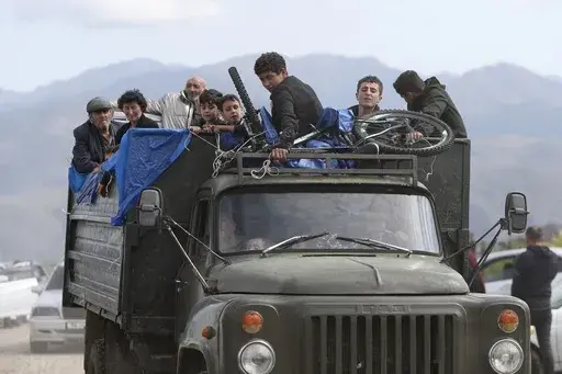 Ethnic Armenians from Nagorno-Karabakh travel on a truck on their way to Kornidzor, Armenia, on Sept. 26, 2023. Israel has quietly helped fuel Azerbaijan’s campaign to recapture Nagorno-Karabakh, officials and experts say, supplying powerful weapons to Azerbaijan ahead of its lightening offensive last month that brought the Armenian enclave in its territory back under its control.(Stepan Poghosyan, Photolure photo via AP, File)