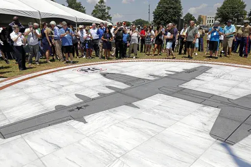Family members and others look at a monument honoring the 15 Marines and one Navy corpsman who died in a July 10, 2017, U.S. military plane crash near Itta Bena, Miss., during an unveiling ceremony for the monument on July 14, 2018. Federal prosecutors said Wednesday, July 3, 2024, that a former engineer at a U.S. military air logistics center has been charged with making false statements and obstructing justice during the criminal investigation into the crash of the plane that had the call sign
