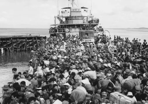 Refugees crowd a naval vessel docked at Vung Tau, a coastal town near Saigon on April 9, 1975. The Immigration and Nationality Act of 1952 lets the president grant entry for humanitarian reasons and matters of public interest. Previous administrations have admitted large numbers of Hungarians, Vietnamese and Cubans. (AP Photo/Kim Ki Sam, File)