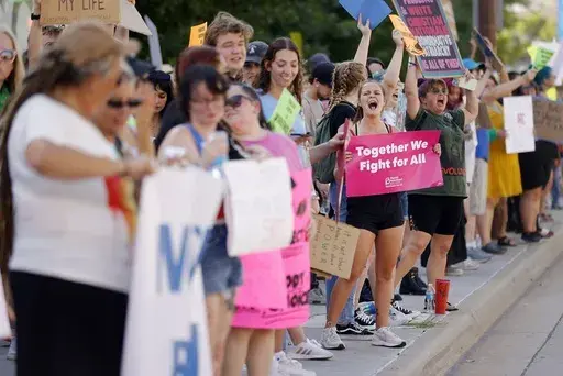 Zoe Staires protests against the U.S. Supreme Court overturning Roe v. Wade, June 24, 2022, in Tulsa, Okla. (Mike Simons/Tulsa World via AP, File)/Tulsa World via AP)
