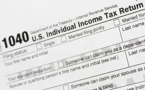 A portion of the 1040 U.S. Individual Income Tax Return form is shown July 24, 2018, in New York. The IRS has been tasked with looking into how to create a government-operated electronic free-file tax return system for all. Congress has directed the IRS to report in on how such a system might work. (AP Photo/Mark Lennihan, File)