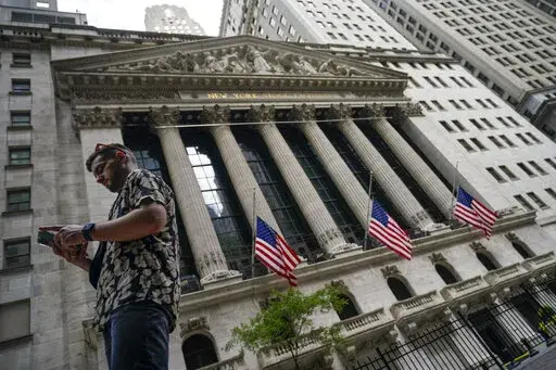 Pedestrians walk past the New York Stock Exchange, on July 8, 2022, in New York.  Stocks rose on Wall Street, Friday, Sept. 9, keeping the market on a track to break a three-week losing streak.  (AP Photo/John Minchillo, file)