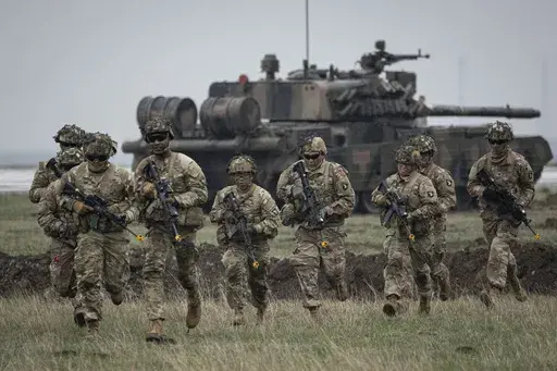 Servicemen of the United States 101 Airborne Division run during an exercise at the Mihail Kogalniceanu Air Base, near the Black Sea port of Constanta, Romania, Friday, March 31, 2023. Russia’s armed forces are bruised but by no means beaten in the war in Ukraine, a top NATO military officer said Monday, as he laid out the biggest revamp to the organization’s military plans since the Cold War should Moscow dare to widen the conflict. (AP Photo/Vadim Ghirda, File)