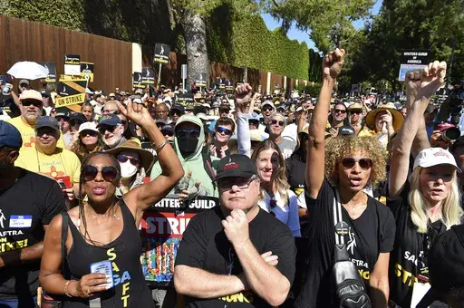 Sean Astin, center, Michelle Hurd, second right, and marchers attend the Day of Solidarity union rally on Tuesday, Aug. 22, 2023, at Disney Studios in Burbank, Calif. The event includes members of SAG-AFTRA, the WGA and the AFL-CIO. (Photo by Jordan Strauss/Invision/AP)