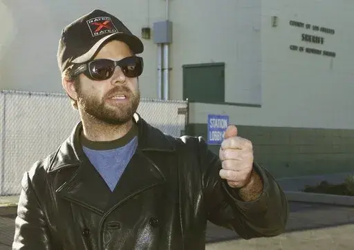 One-time child actor Adam Rich, who starred in the 1970s TV show "Eight is Enough," walks out of a sheriff's station after posting bail in City of Industry, Calif., Dec. 18, 2002. Rich, the child actor with a pageboy mop top who charmed TV audiences as “America's little brother” on “Eight is Enough,” died Saturday, Jan. 7, 2023, in the Brentwood section of Los Angeles. He was 54. The cause of death was under investigation but was not considered suspicious. (AP Photo/Jean-Marc Bouju)