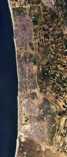 This satellite photo from Planet Labs PBC shows the Gaza Strip on Tuesday, Jan 30, 2024. Satellite photos show new demolition along a 1-kilometer-deep path on the Gaza Strip's border with Israel, according an analysis by The Associated Press and expert reports. The destruction comes as Israel has said it wants to establish a buffer zone there, further tearing away at land the Palestinians want for a state over international objections. (Planet Labs PBC via AP)