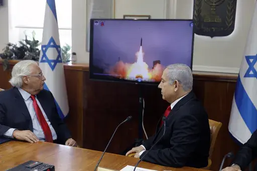 Israeli Prime Minister Benjamin Netanyahu, right, and US Ambassador to Israel David Friedman watch a video which shows the launch of the Arrow 3 hypersonic anti-ballistic missile during a cabinet meeting in Jerusalem on July 28 2019. The United States cleared a weapons agreement between Israel and Germany that marks Israel’s largest-ever defense deal on Thursday Aug. 17, 2023. (Menahem Kahana/Pool via AP, File)