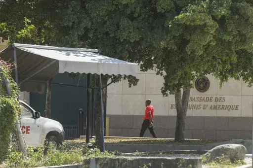 A man enters the U.S. embassy in Port-au-Prince, Haiti, Sunday, March 10, 2024. A charter flight carrying dozens of U.S. citizens fleeing spiraling gang violence in Haiti landed Sunday, March 17, 2024, in Miami, U.S. State Department officials said. (AP Photo/Odelyn Joseph. File)