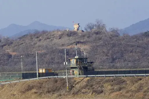 Military guard posts of North Korea, rear, and South Korea, front, are seen in Paju, near the border with North Korea, South Korea, Sunday, Jan. 2, 2022. South Korea's military said Sunday that an unidentified person crossed the heavily fortified border into North Korea. (AP Photo/Ahn Young-joon)