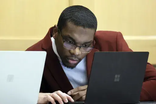 Shooting suspect Michael Boatwright looks at his attorney's computer at the defense table on the fourth day of jury deliberations in the XXXTentacion murder trial at the Broward County Courthouse in Fort Lauderdale, Fla., Monday, March 13, 2023. Emerging rapper XXXTentacion, born Jahseh Onfroy, 20, was killed during a robbery outside of Riva Motorsports in Pompano Beach in 2018, allegedly by defendants Boatwright, Trayvon Newsome, and Dedrick Williams. (Amy Beth Bennett/South Florida Sun-Sentine