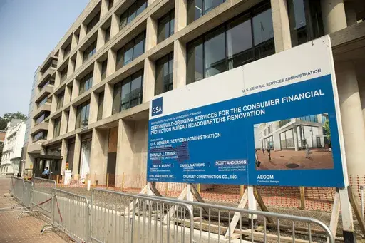 A sign stands at the construction site for the Consumer Financial Protection Bureau's headquarters in Washington, Aug. 27, 2018. (AP Photo/Andrew Harnik, file)