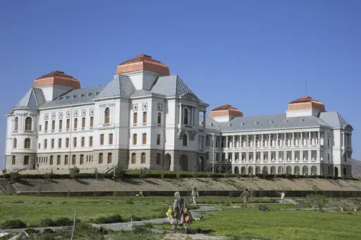 Afghans work in the garden of the renovated Darul Aman Palace in Kabul, Afghanistan, Wednesday, April 24, 2024. (AP Photo/Siddiqullah Alizai)