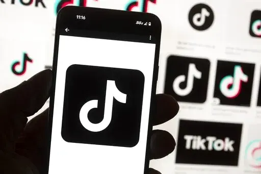 The TikTok logo is seen on a cell phone on Oct. 14, 2022, in Boston. The White House is giving all federal agencies 30 days to wipe TikTok off all government devices, as the Chinese-owned social media app comes under increasing scrutiny in Washington over security concerns. (AP Photo/Michael Dwyer, File)