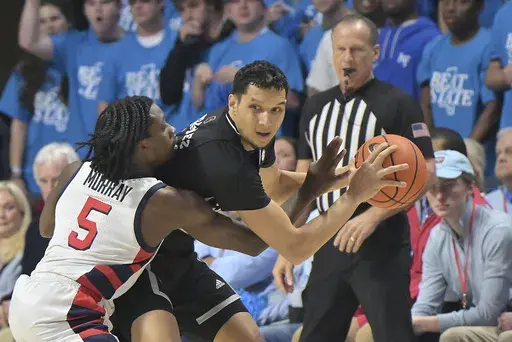 Mississippi guard Jaylen Murray (5) fouls Mississippi State forward RJ Melendez during the first half of an NCAA college basketball game in Oxford, Miss., Saturday, Feb. 15, 2025. (AP Photo/Bruce Newman)