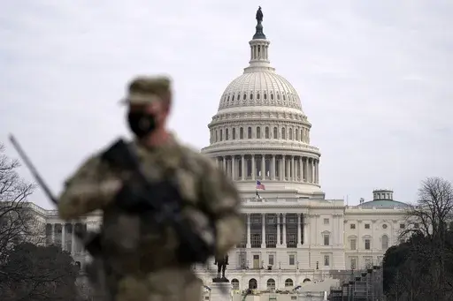 A member of the National Guard patrols the area outside of the U.S. Capitol at the Capitol in Washington, Wednesday, Feb. 10, 2021. The House passed a defense policy bill Thursday, Dec. 14, 2023, that authorizes the biggest pay raise for troops in more than two decades, overcoming objections from some conservatives concerned the measure did not do enough to restrict the Pentagon's diversity initiatives, abortion travel policy and gender-affirming health care for transgender service members. (AP 