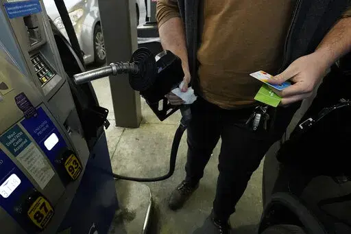 A customer prepares to pump gasoline into his car at a Sam's Club fuel island in Gulfport, Miss., Feb. 19, 2022. The U.S. economy shrank last quarter for the first time since the pandemic recession struck two years ago, Thursday, April 28, 2022, contracting at a 1.4% annual rate, but consumers and businesses kept spending in a sign of underlying resilience.  (AP Photo/Rogelio V. Solis)