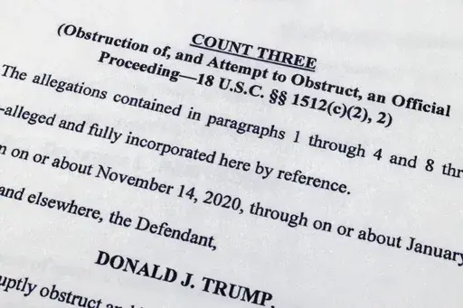 The indictment against former President Donald Trump charging him by the Justice Department for his efforts to overturn the results of the 2020 presidential election is photographed Tuesday, Aug. 1, 2023, in Washington. (AP Photo/Jon Elswick)