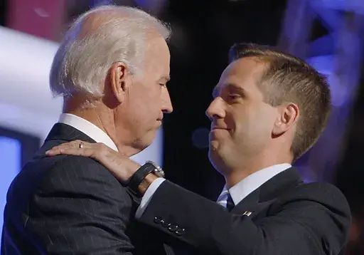 Then-Democratic vice presidential candidate Sen. Joe Biden, D-Del., left, embraces his son Beau Biden on stage at the Democratic National Convention in Denver, Aug. 27, 2008. (AP Photo/Charles Dharapak, File)