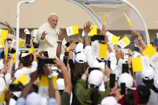 Pope Francis arrives to celebrate mass at the Bahrain National Stadium in Riffa, Bahrain, Saturday, Nov. 5, 2022. Pope Francis is making the November 3-6 visit to participate in a government-sponsored conference on East-West dialogue and to minister to Bahrain's tiny Catholic community, part of his effort to pursue dialogue with the Muslim world. (AP Photo/Alessandra Tarantino)