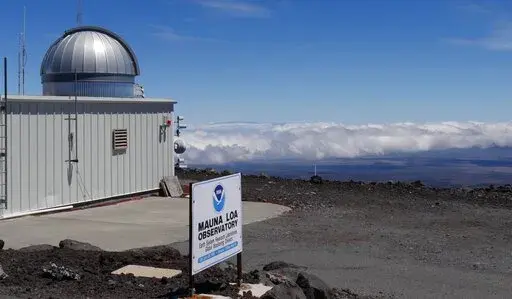 This 2019 photo provided by NOAA shows the Mauna Loa Atmospheric Baseline Observatory, high atop Hawaii's largest mountain in order to sample well-mixed background air free of local pollution. Mauna Loa’s volcano eruption has temporarily knocked off power to the world’s premier station that measures heat-trapping carbon dioxide in the atmosphere, but officials said that there are hundreds of other carbon dioxide monitoring sites across the globe. (Susan Cobb/NOAA Global Monitoring Laboratory