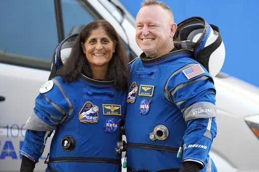 NASA astronauts Suni Williams, left, and Butch Wilmore stand together for a photo enroute to the launch pad at Space Launch Complex 41 Wednesday, June 5, 2024, in Cape Canaveral, Fla., for their liftoff on a Boeing Starliner capsule to the International Space Station. (AP Photo/Chris O'Meara, File)