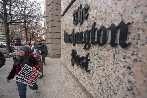 Employees of the Washington Post picket outside the company's offices in downtown Washington, Thursday, Dec. 7, 2023, amid a one-day strike over labor issues. The Washington Post is completing buyouts to more than 200 staffers. (AP Photo/Mark Schiefelbein, File)