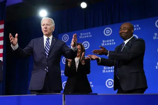 President Joe Biden and Vice President Kamala Harris stand on stage with DNC chair Jaime Harrison at the Democratic National Committee winter meeting, Friday, Feb. 3, 2023, in Philadelphia. (AP Photo/Patrick Semansky)