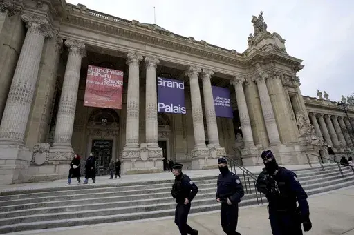 Police patrol outside of the entrance to the Grand Palais, which will be the venue for an upcoming AI Action Summit, in Paris, Sunday, Feb. 9, 2025. (AP Photo/Michel Euler)