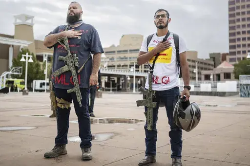 Demonstrators carry their assault rifles to a Second Amendment rally in response to Gov. Michelle Lujan Grisham's recent public health order suspending the conceal and open carry of guns in and around Albuquerque for 30-days, Tuesday, Sept. 12, 2023, in Albuquerque, N.M. Restrictions on carrying guns in public that are tied to an emergency public health order are going under the legal microscope Tuesday, Oct. 3, in New Mexico, where the Democratic governor is testing the boundaries of her author