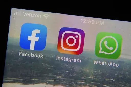 The mobile phone apps for, from left, Facebook, Instagram and WhatsApp are shown on a device in New York. The company that owns Facebook and Instagram said Monday, May 23, 2022, it will begin revealing more details about how advertisers target people with certain political ads, just months before the U.S. Midterm elections. (AP Photo/Richard Drew, File)
