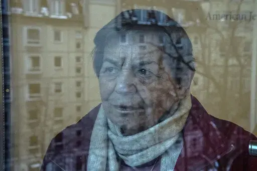 95-year-old Ruth Winkelmann, who is one of the survivors of the Holocaust, looks out of a window in Berlin, Germany, Wednesday, Jan. 17, 2024. Almost 80 years after the Holocaust, about 245,000 Jewish survivors are still living across more than 90 countries. A new report reveals that nearly half of them, or 49%, are living in Israel, 18% in Western Europe, 16% in the United States, and 12% in countries of the former Soviet Union. (AP Photo/Ebrahim Noroozi)
