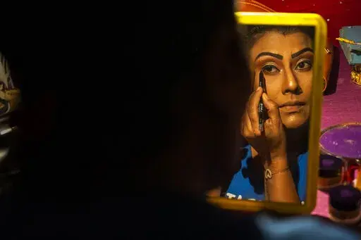 Prastuti Parashar, owner and lead actor of Awahan theater, prepares for a performance at Xetali village, east of Gauhati, India, Wednesday, April 6, 2022. Traveling theater groups in India's northeastern state of Assam are reviving the local art and culture scene after the COVID-19 pandemic forced a pause in their performances for a year and a half. “The public response has been very good. They love live performances. We have no competition from television and the digital boom,” said Parasha